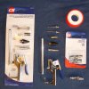 Kobalt 7 Piece Blow Gun Kit from Lowes, or Campbell Hausfeld 7 Piece Air Blow Gun Kit from TSC, were used for the assembly of the Foggy Window Repair Kits. 

Additionally, a Campbell Hausfeld (or similar) 1/4 inch I/M style plug connector was purchased to facilitate the connection of the sprayer blow gun to the 20 foot sprayer hose coming from the Olympic Premium Deck Care Sprayer. 

You can buy similar blow gun kits and connectors from most hardware stores to arrive at a combination which will connect nicely to your preferred sprayer/tubing and 90 degree sprayer tip.
