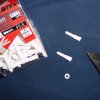 Cobra Plastic Screw Anchors sized number 6-8 are available in most hardware stores.
 
The flat ends can be removed with snips.

These can be easily shaped and sized with a sharp knife to fit through both window panes from inside the property.

